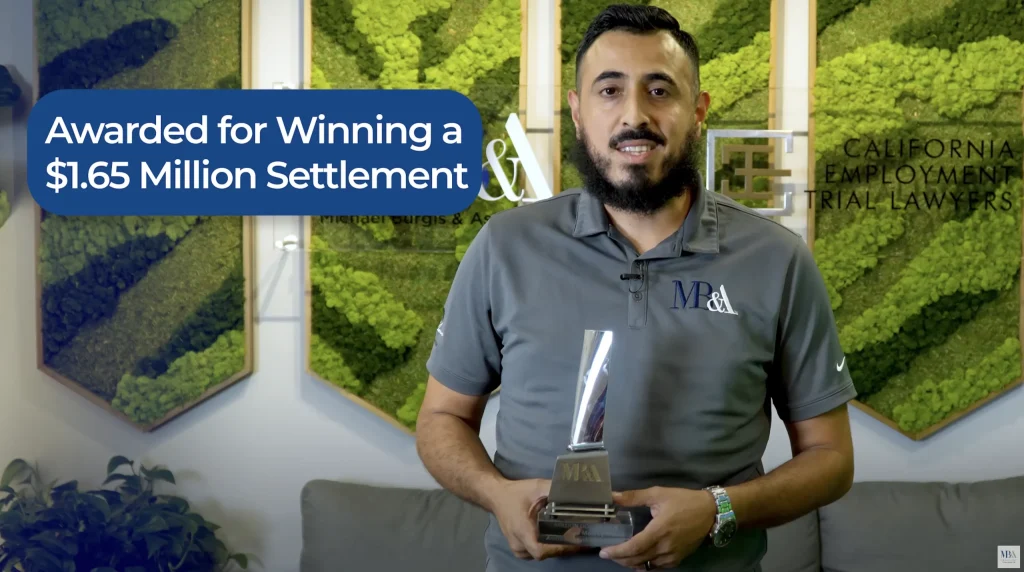 Alex Monroy proudly holding award trophy for securing $1.65 million settlement in California workers' compensation case