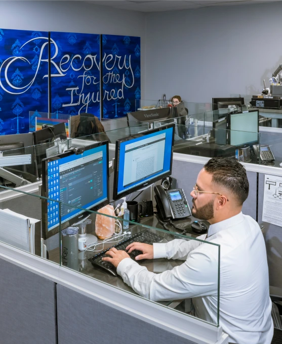 Burgis Law office interior with Recovery for the Injured mural and staff at work in 2026
