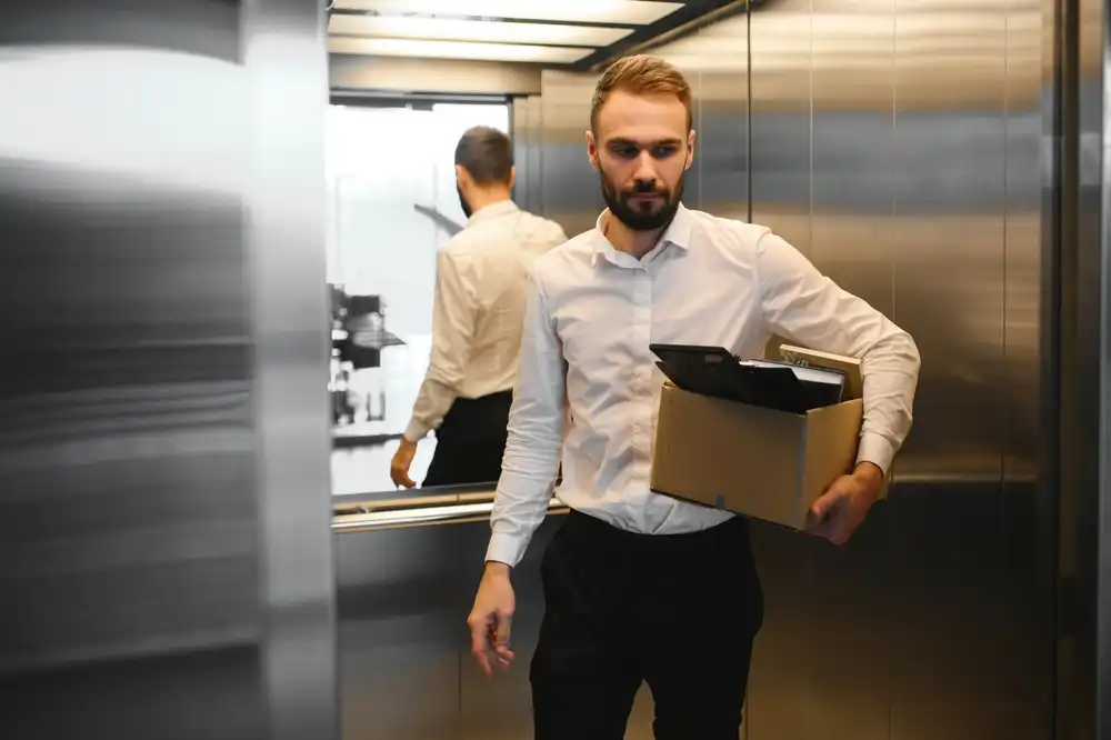 Employee carrying box after being wrongfully terminated, representing employment law cases